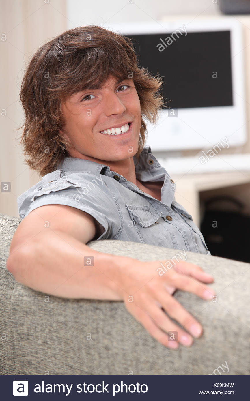 Portrait Of A Young Man With A Shaggy Haircut Stock Photo
