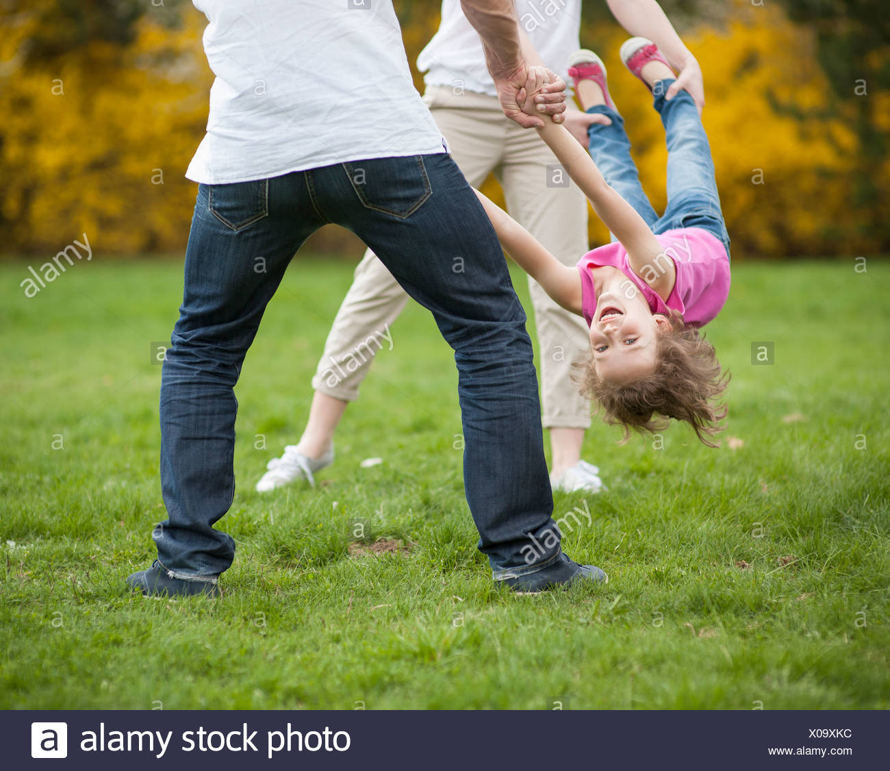Parents Swinging Child Between Them High Resolution Stock Photography