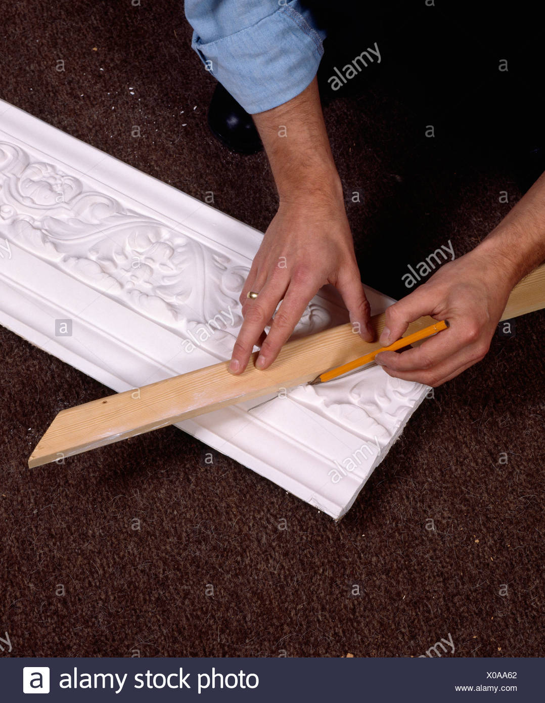 Close Up Of Man Repairing Plaster Ceiling Cornice Stock Photo