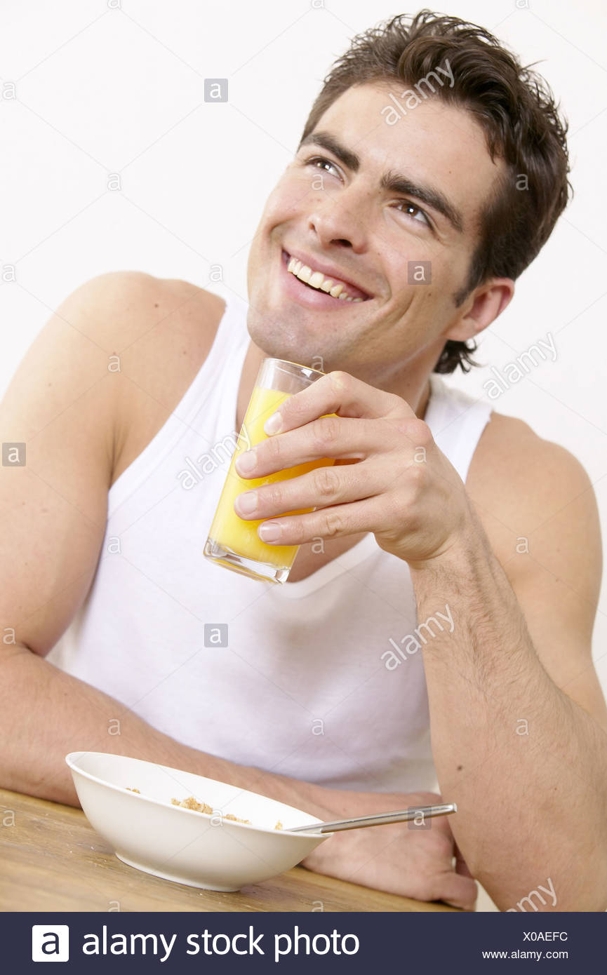 Male Dark Brown Hair Wearing White Vest Top Holding Glass Of