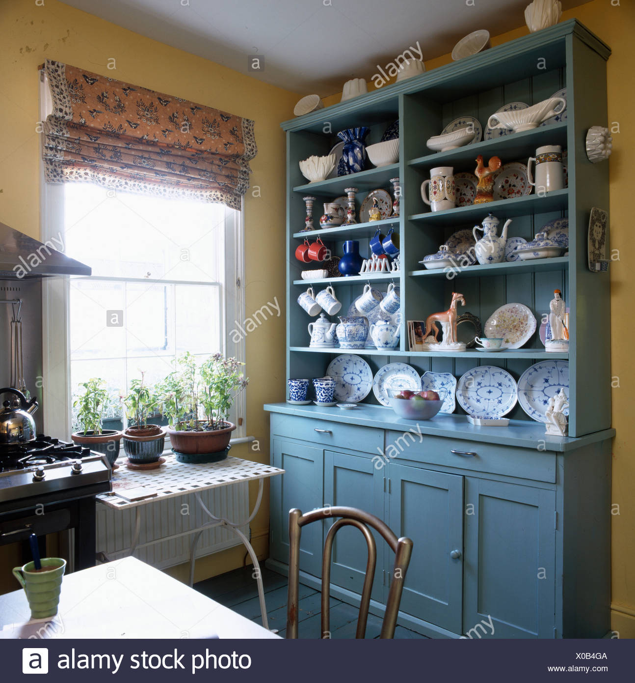 Crockery And China On Large Blue Painted Dresser In Traditional