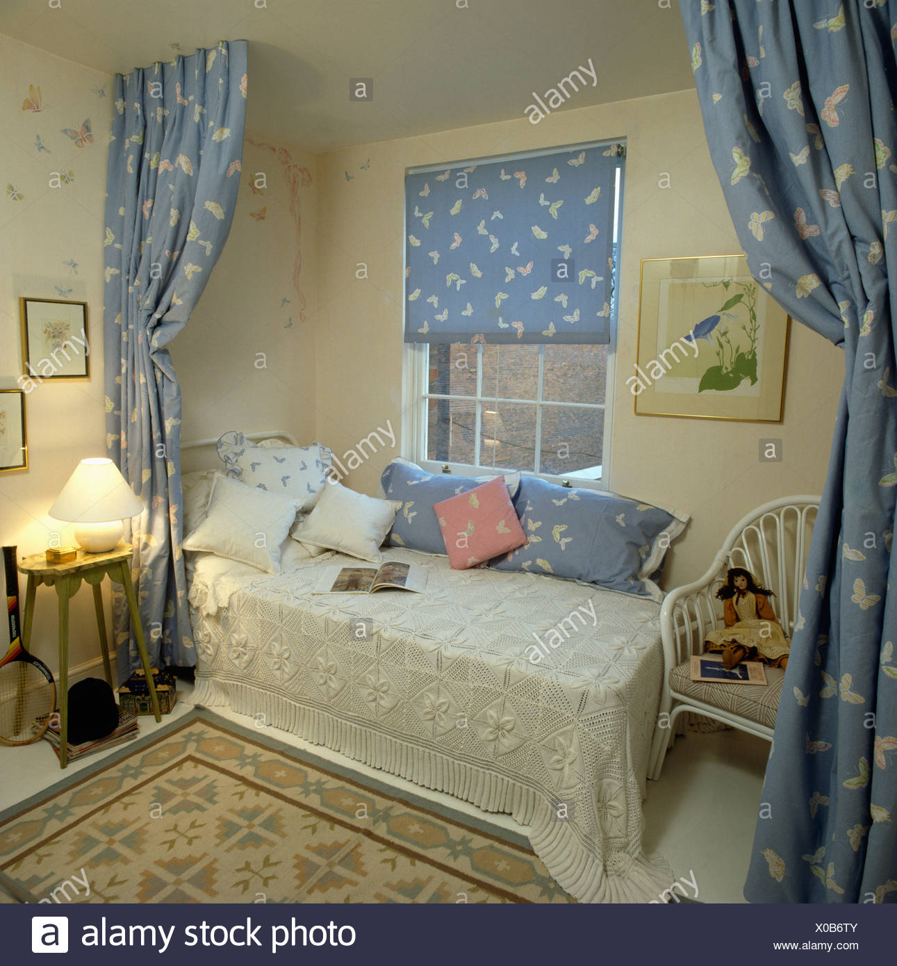 Cream Crochet Blanket On Bed Beneath Window With Patterned