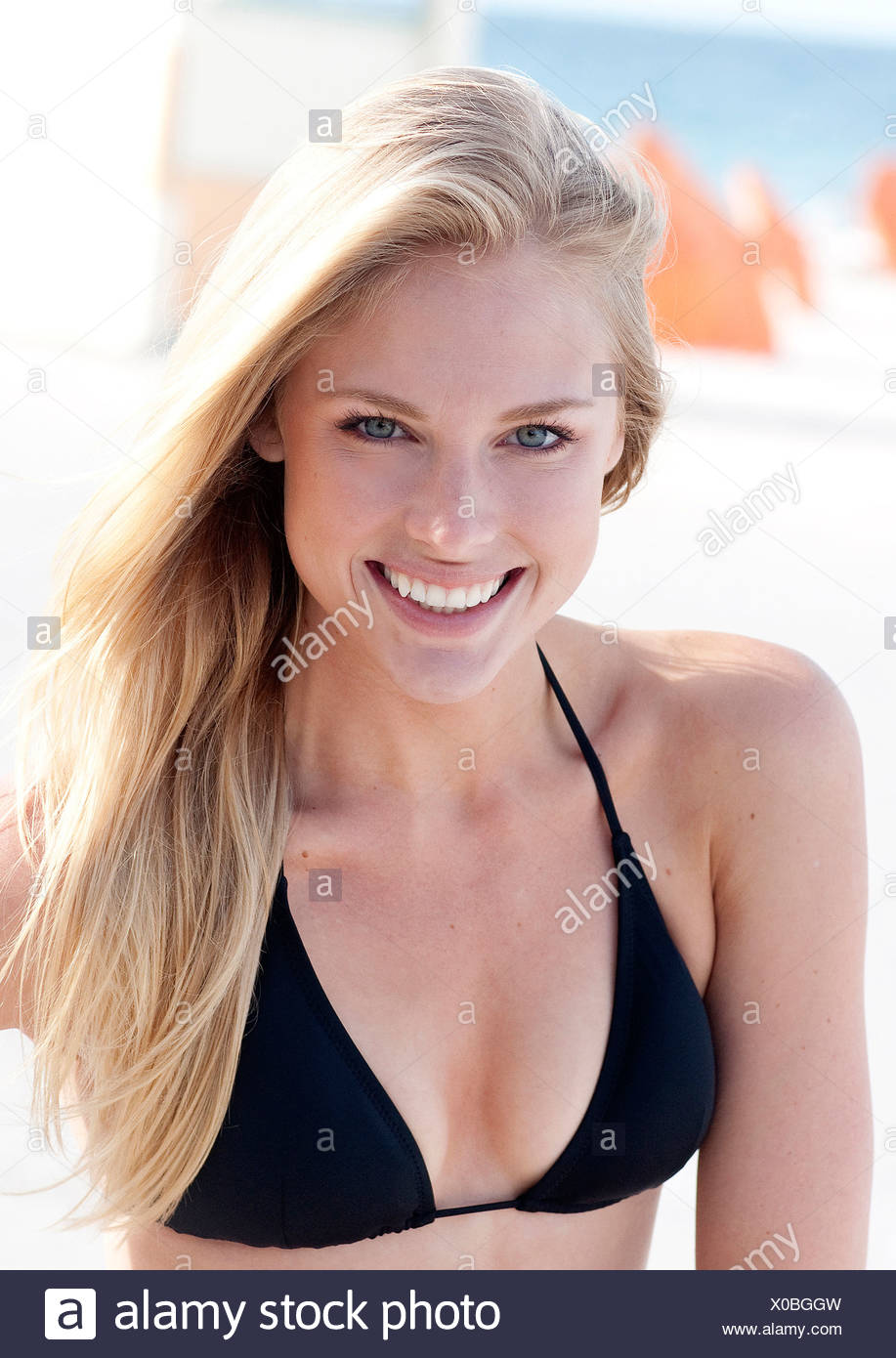 Female With Long Straight Blonde Hair Wearing Black Bikini