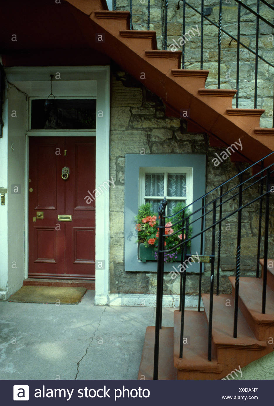 Exterior Of Basement Apartment With A Brown Front Door Below