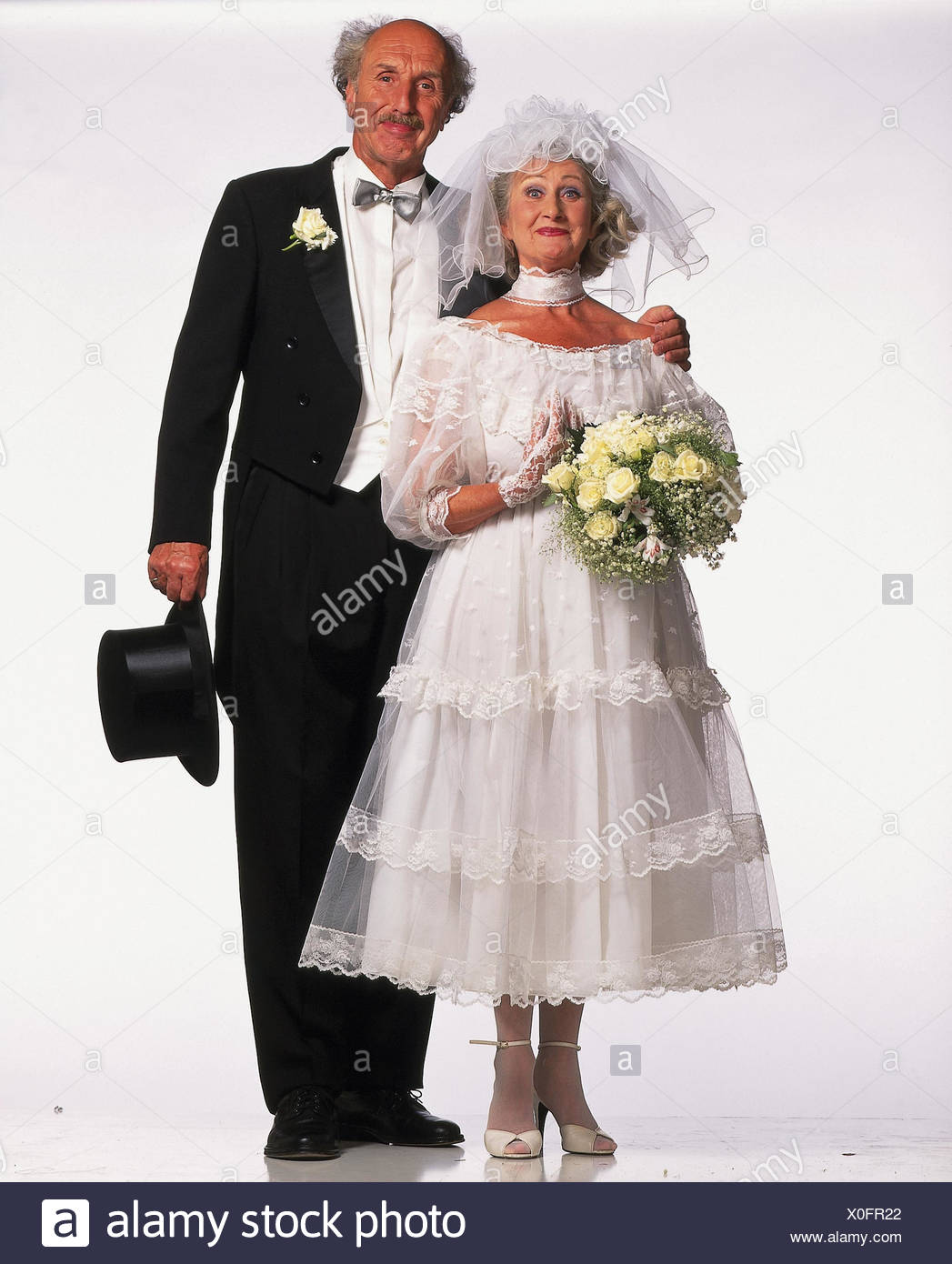 Bride And Groom Senior Citizens Stand Wedding Dress White