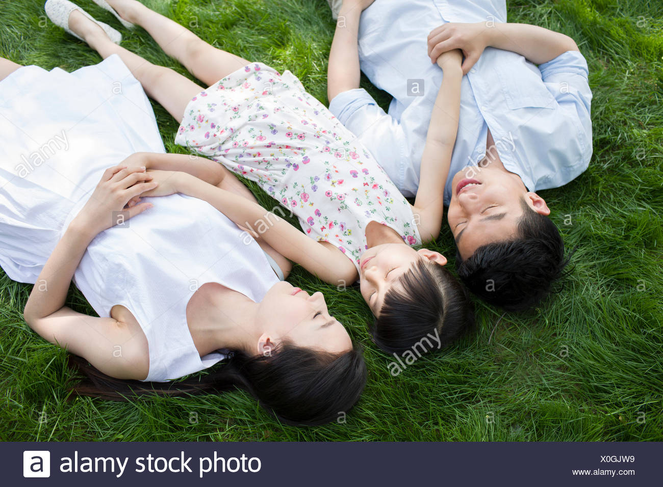 Happy Family Lying On Grass High Resolution Stock Photography and ...