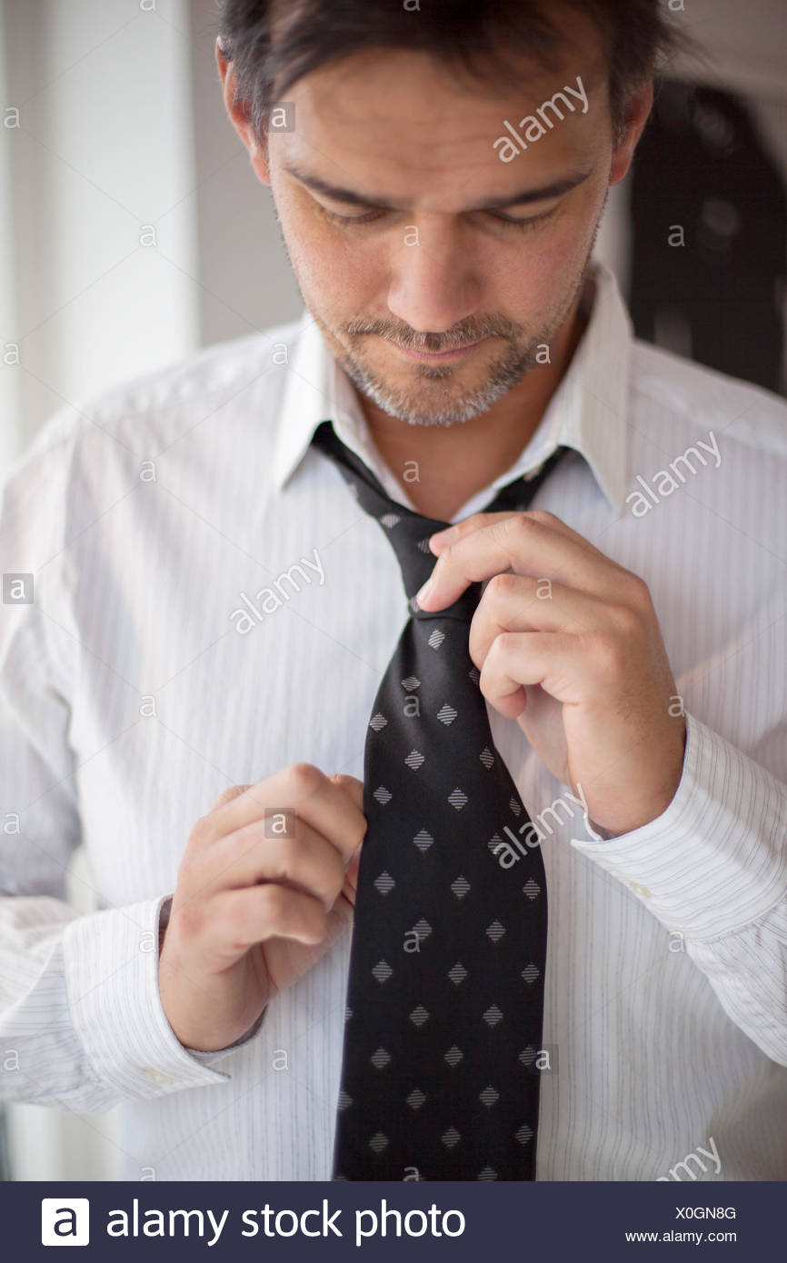 Man Putting On Tie High Resolution Stock Photography and Images Alamy