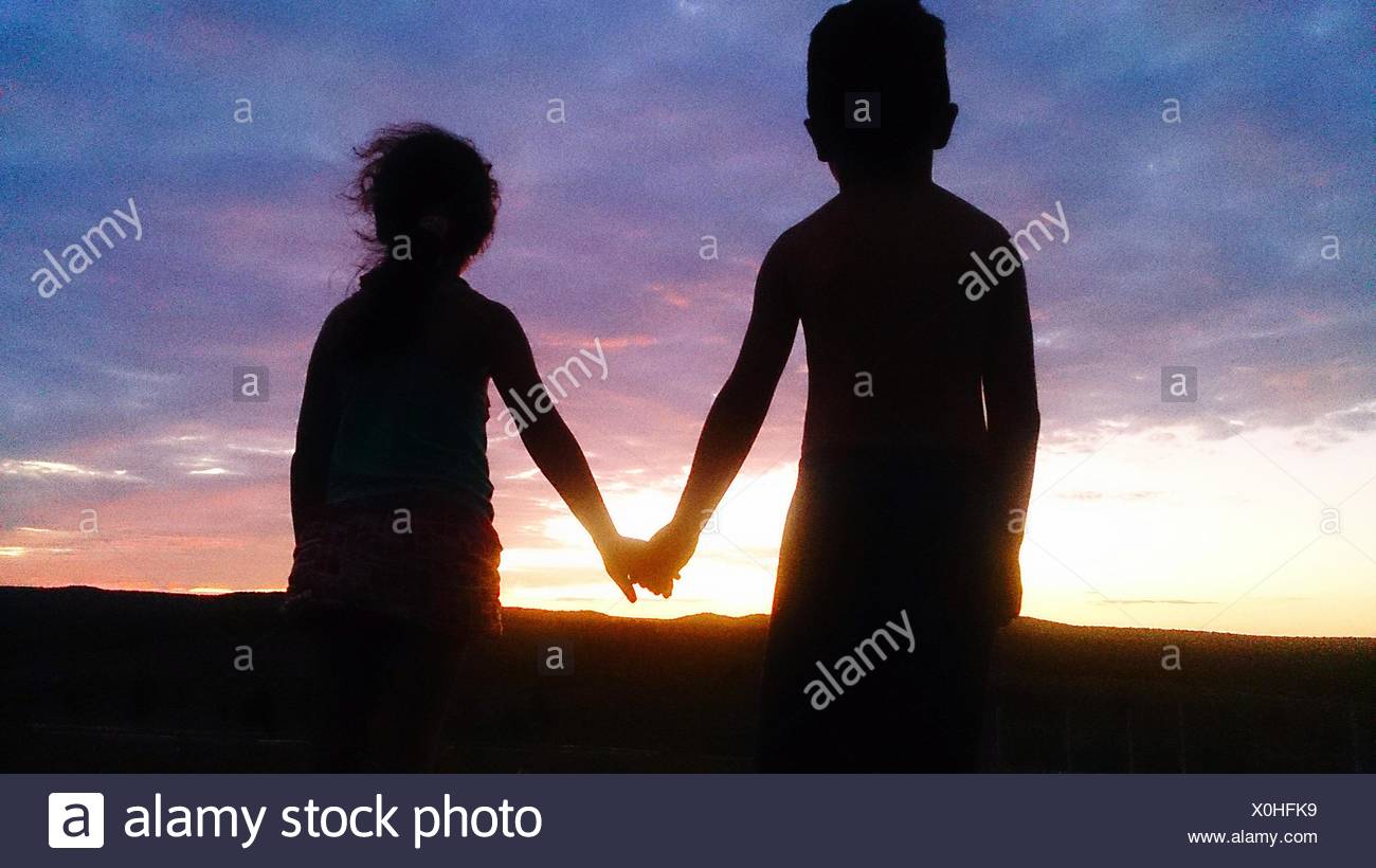 Rear View Of Boy And Girl Holding Hands Against Cloudy Sky During Sunset Stock Photo Alamy Rear View Of Boy And Girl Holding Hands Against Cloudy Sky During Sunset Stock Photo Alamy