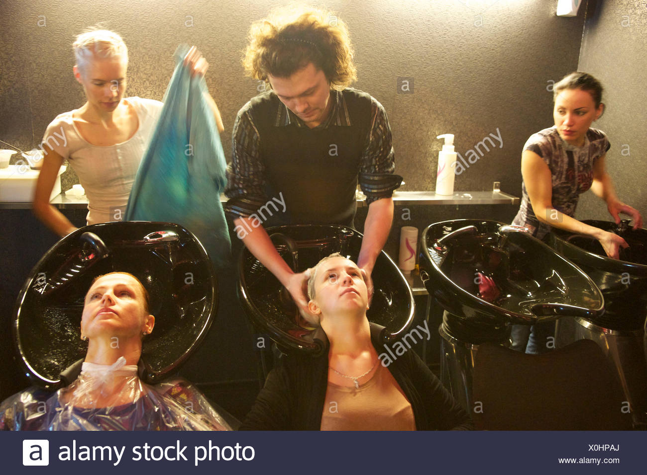 A Hair Stylist At His School Improving His Education Stock Photo