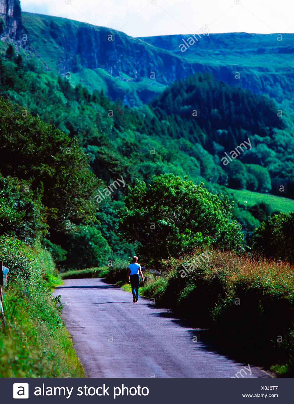 Rear View Of A Person Walking On Road Stock Photo
