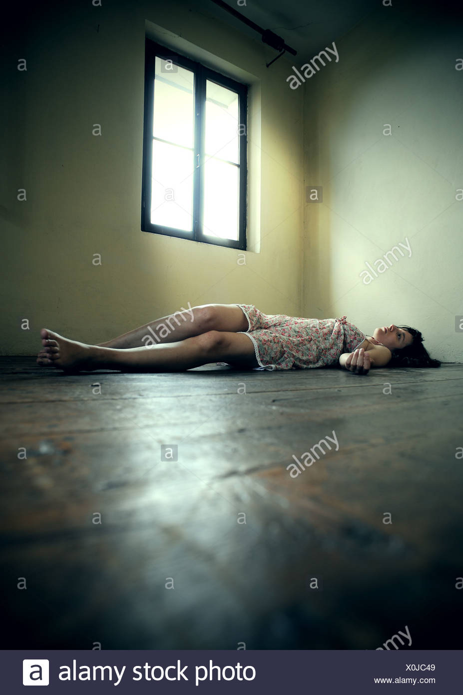 Dead Woman Lying On The Wooden Floor Empty Room Stock Photo