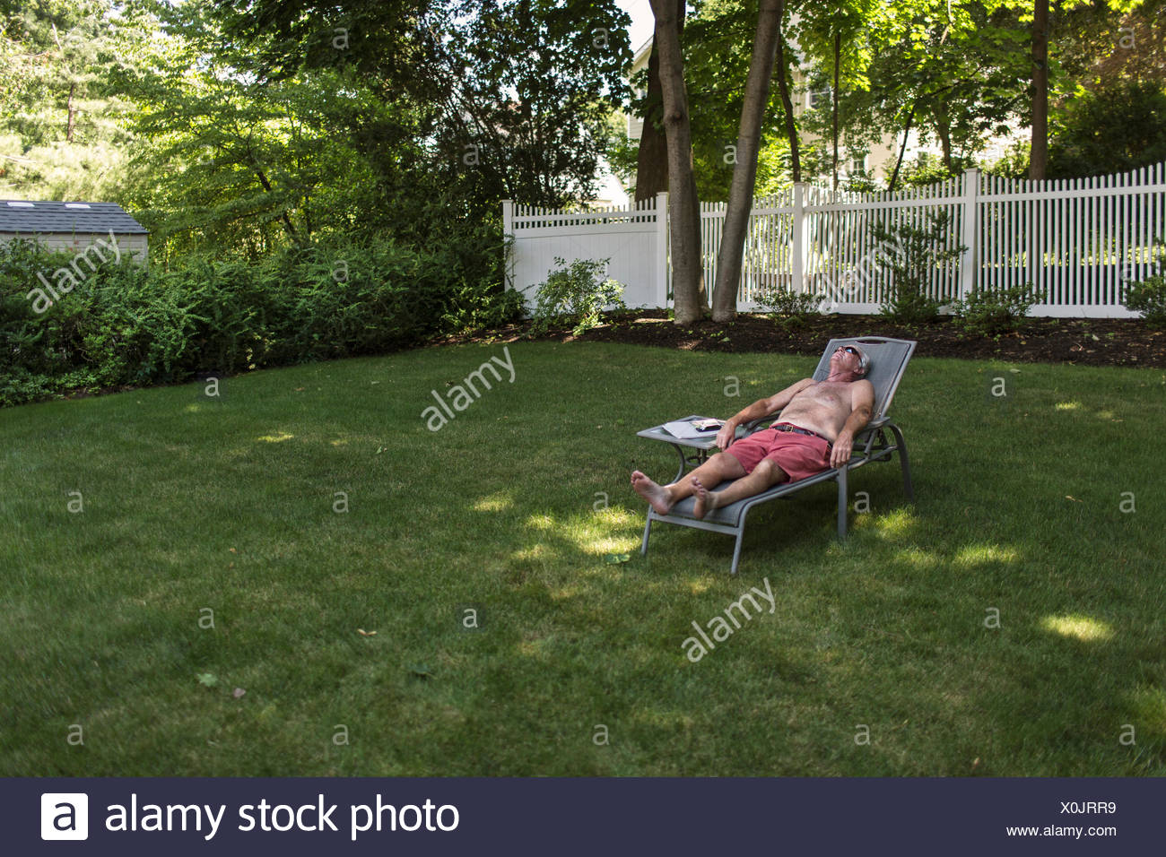 Private Backyard Sunbathing / Man Sunbathing In Garden High Resolution