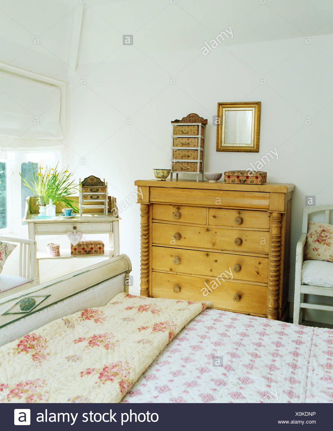 Rose Patterned Quilt And Duvet On Bed In White Country Bedroom