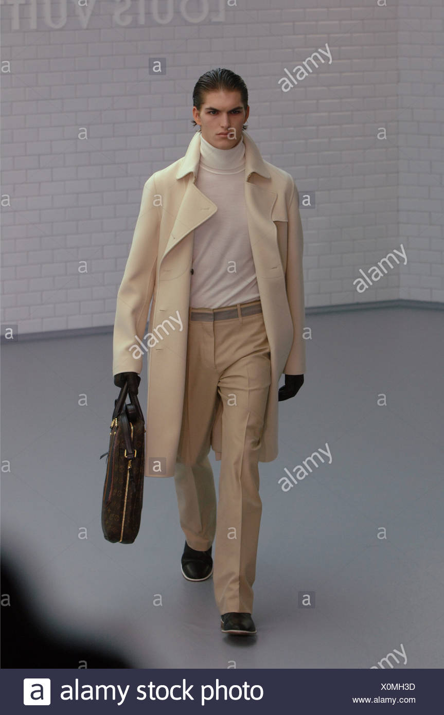 Louis Vuitton Menswear Paris Ready to Wear Model dark hair slicked back  wearing fine ivory poloneck under cream wool coat biege Stock Photo - Alamy