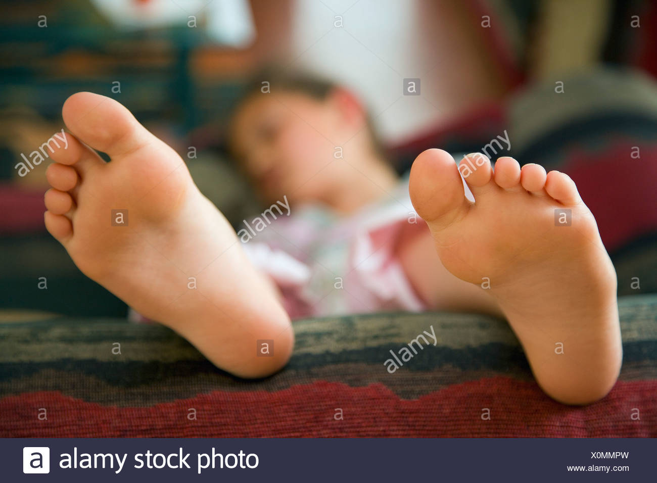 Barefoot Girl Lying On Couch Stock Photos & Barefoot Girl Lying On