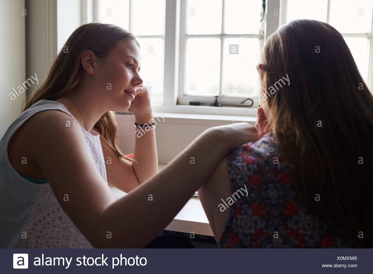 Teenage Girl Comforting Friend Suffering With Depression Stock