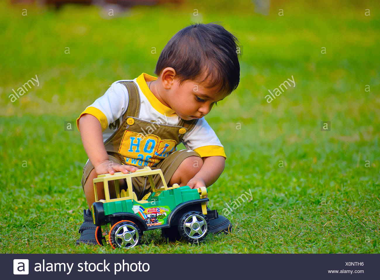 child playing with toy car