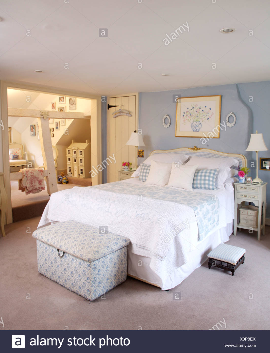 Blue White Ottoman Below Bed With White Linen And Blue