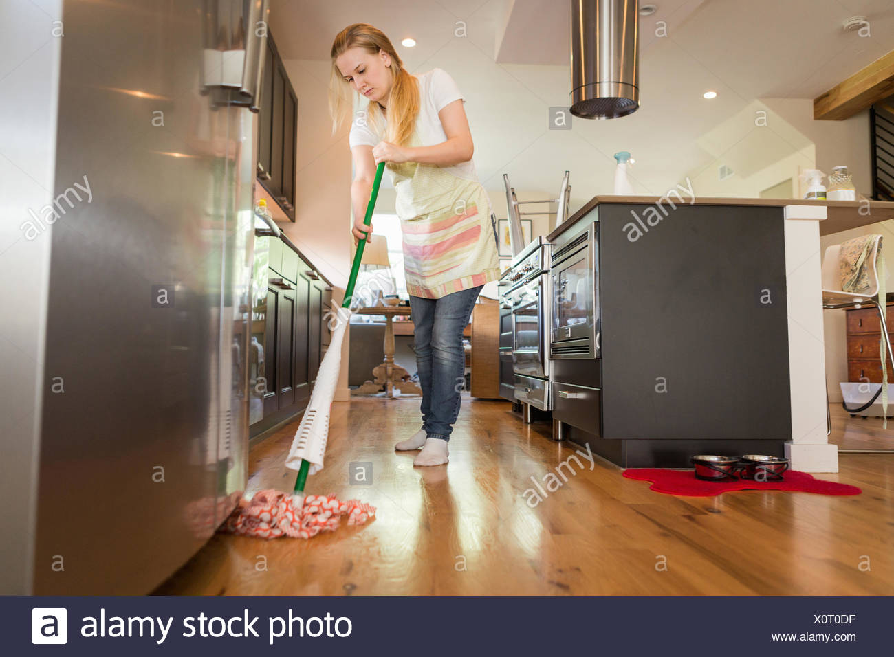 Young woman mopping with green cleaning products Stock Photo
