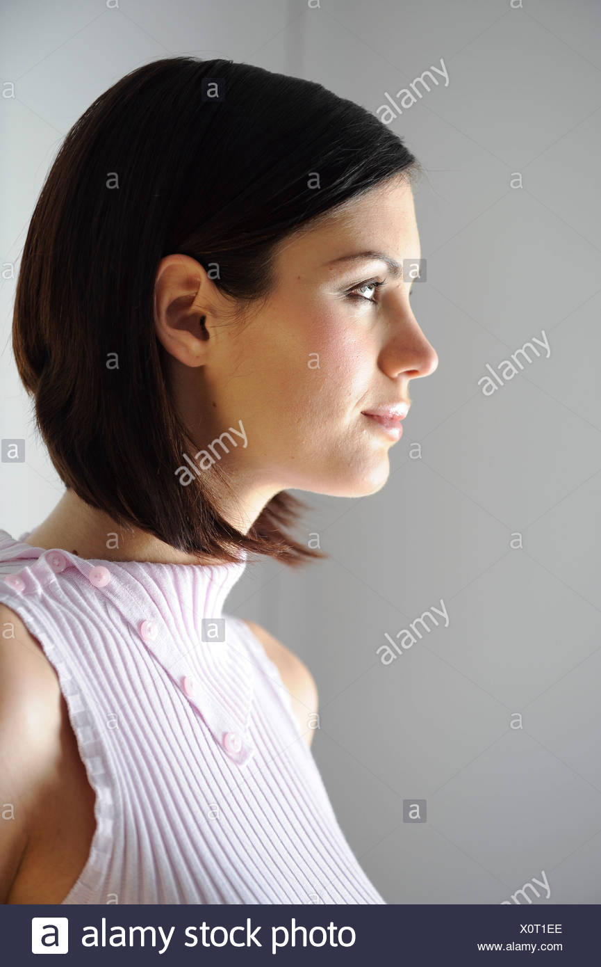 Female Short Brunette Hair And Dark Eye Make Up And Soft Pink
