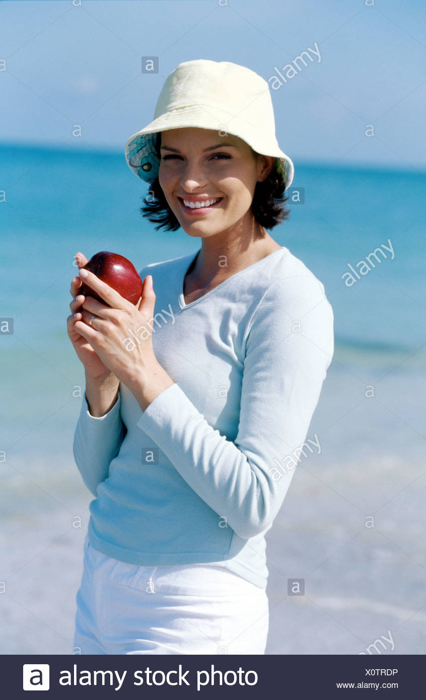 Female Short Brunette Hair Wearing Blue Top White Shorts And