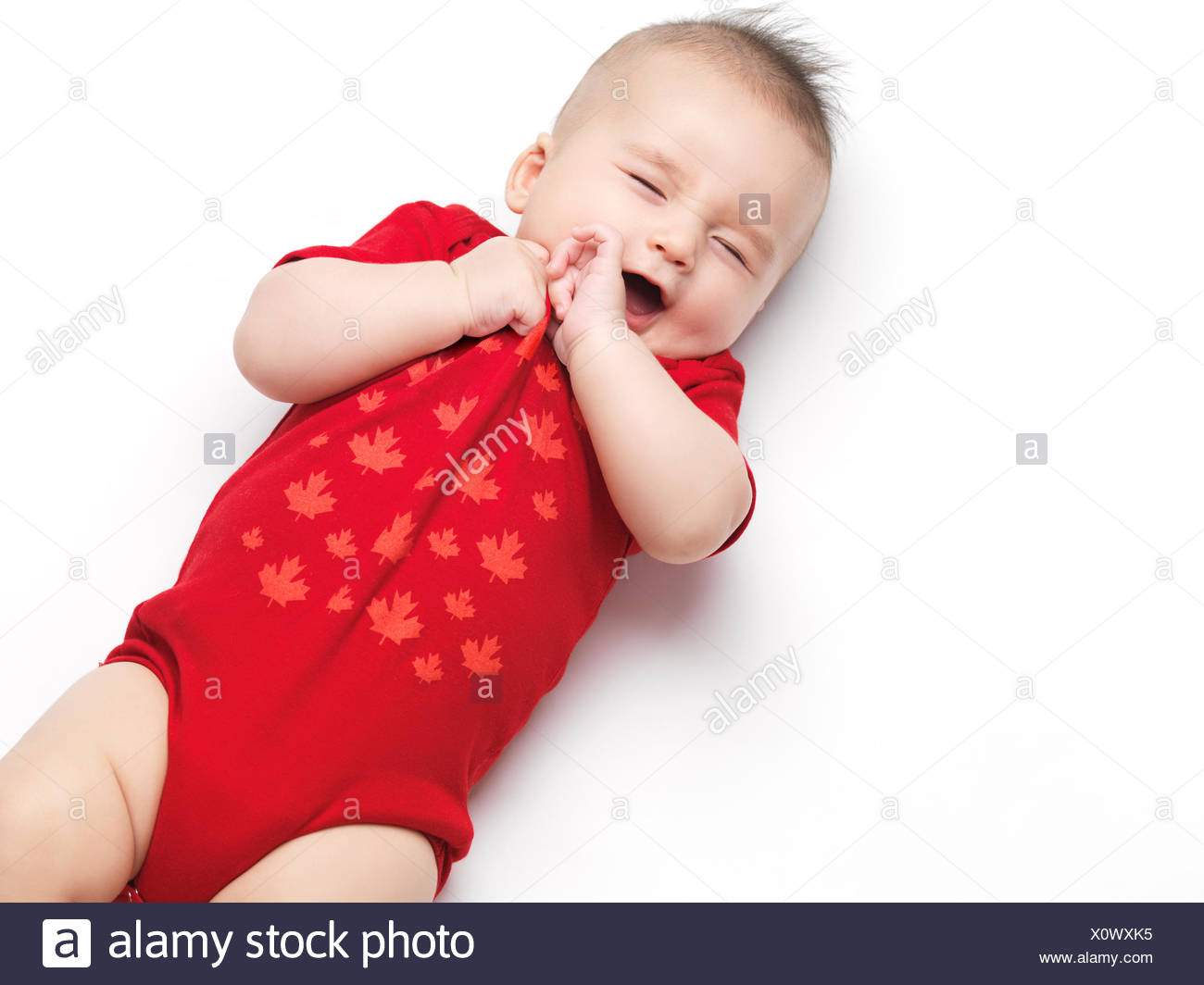 Baby boy, four months, wearing red romper suit Stock Photo - Alamy