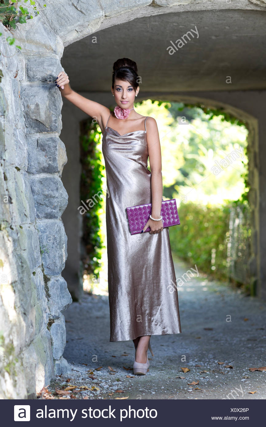 Young Woman With An Updo Hairstyle Long Silvery Evening Dress