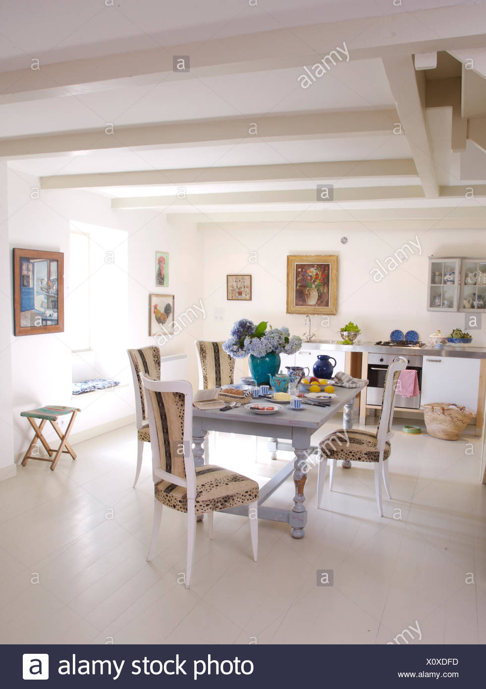 Upholstered White Painted Chairs At Painted Table In French Country
