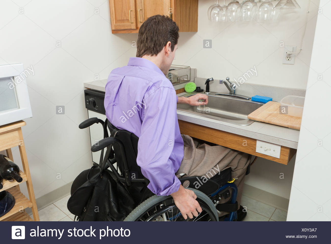 Man In Wheelchair With Spinal Cord Injury Preparing To Wash