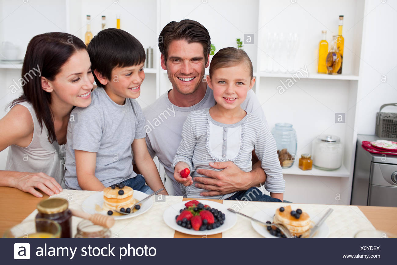 Young Family Eating Fruits And Pancakes For Breakfast Stock Photo Alamy