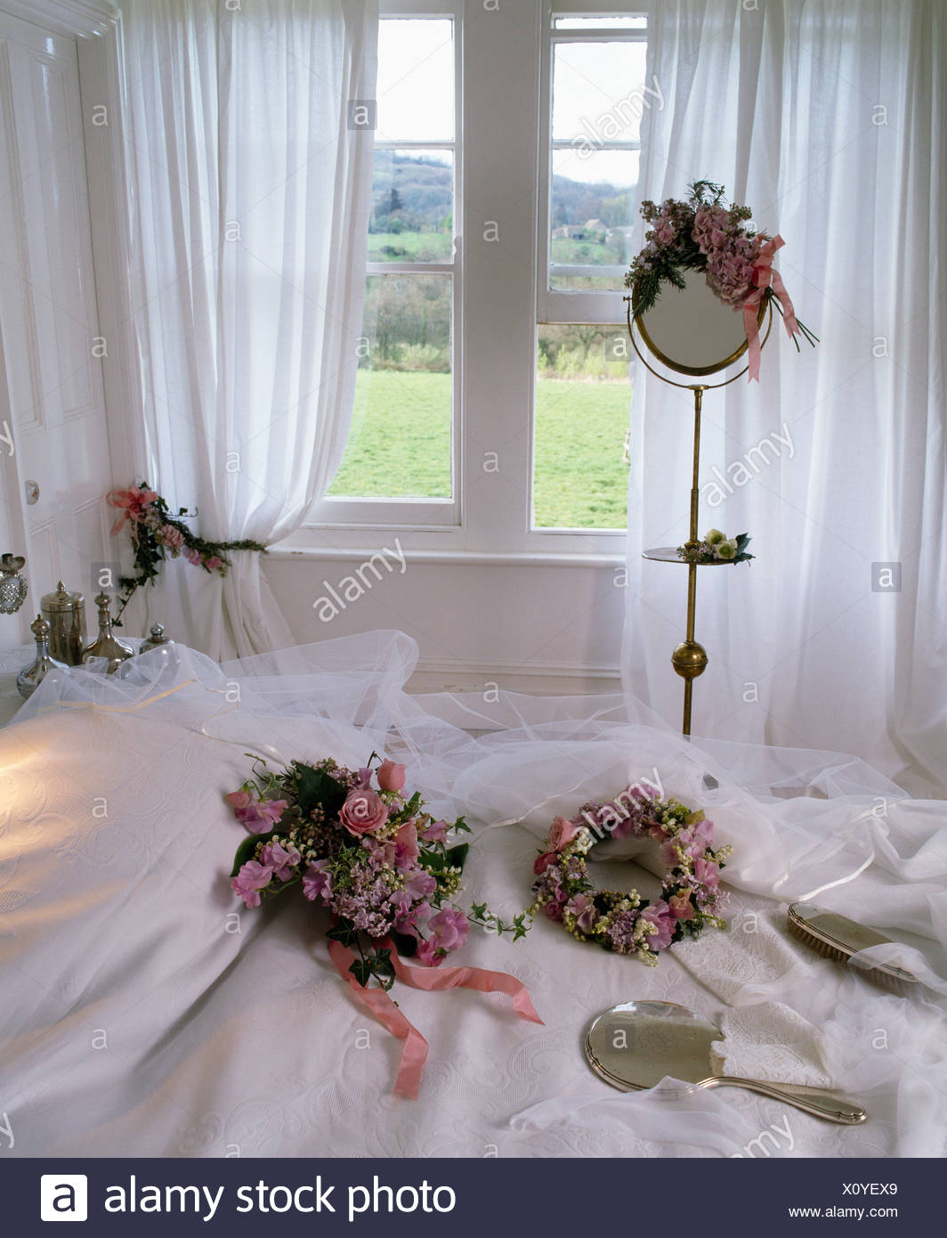 Floral Wedding Head Dresses And Veil On White Bed In Country