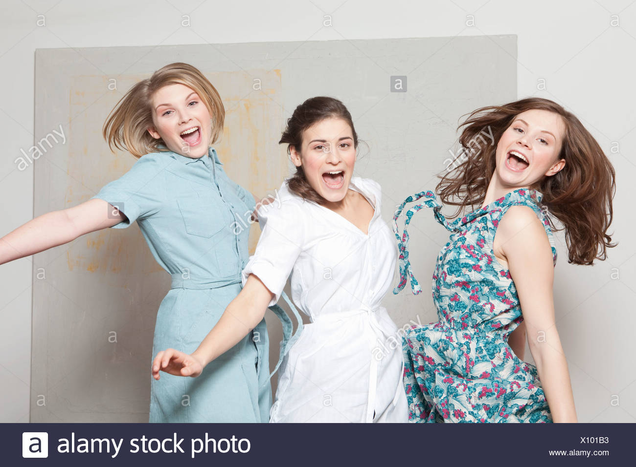 Three women jumping and jubilating Stock Photo