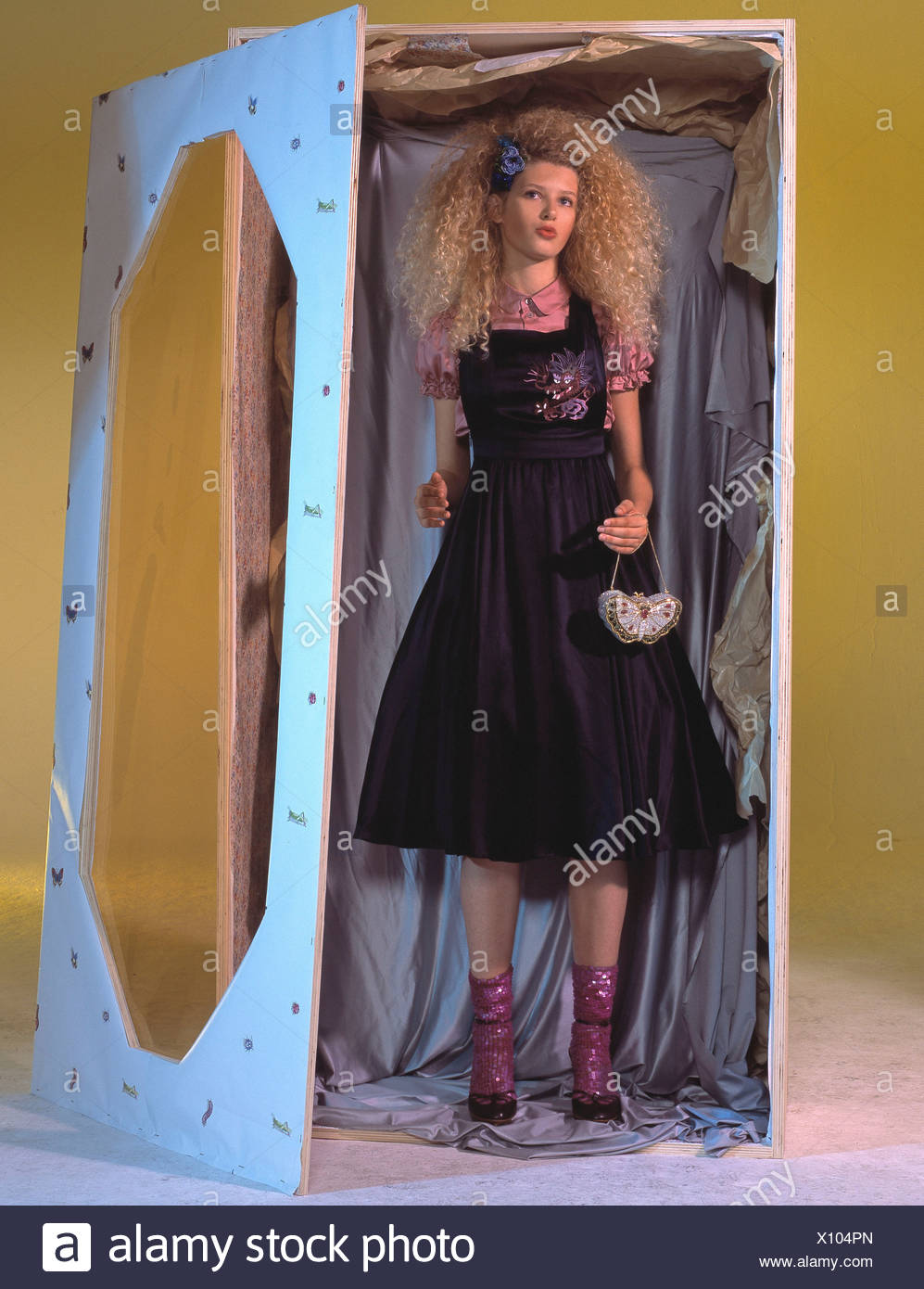 Female Very Curly Blonde Hair Blue Ribbon On One Side Wearing Pink