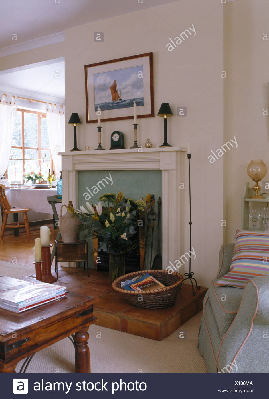 White Sitting Room With Wicker Basket And Vase Of White Lilies On