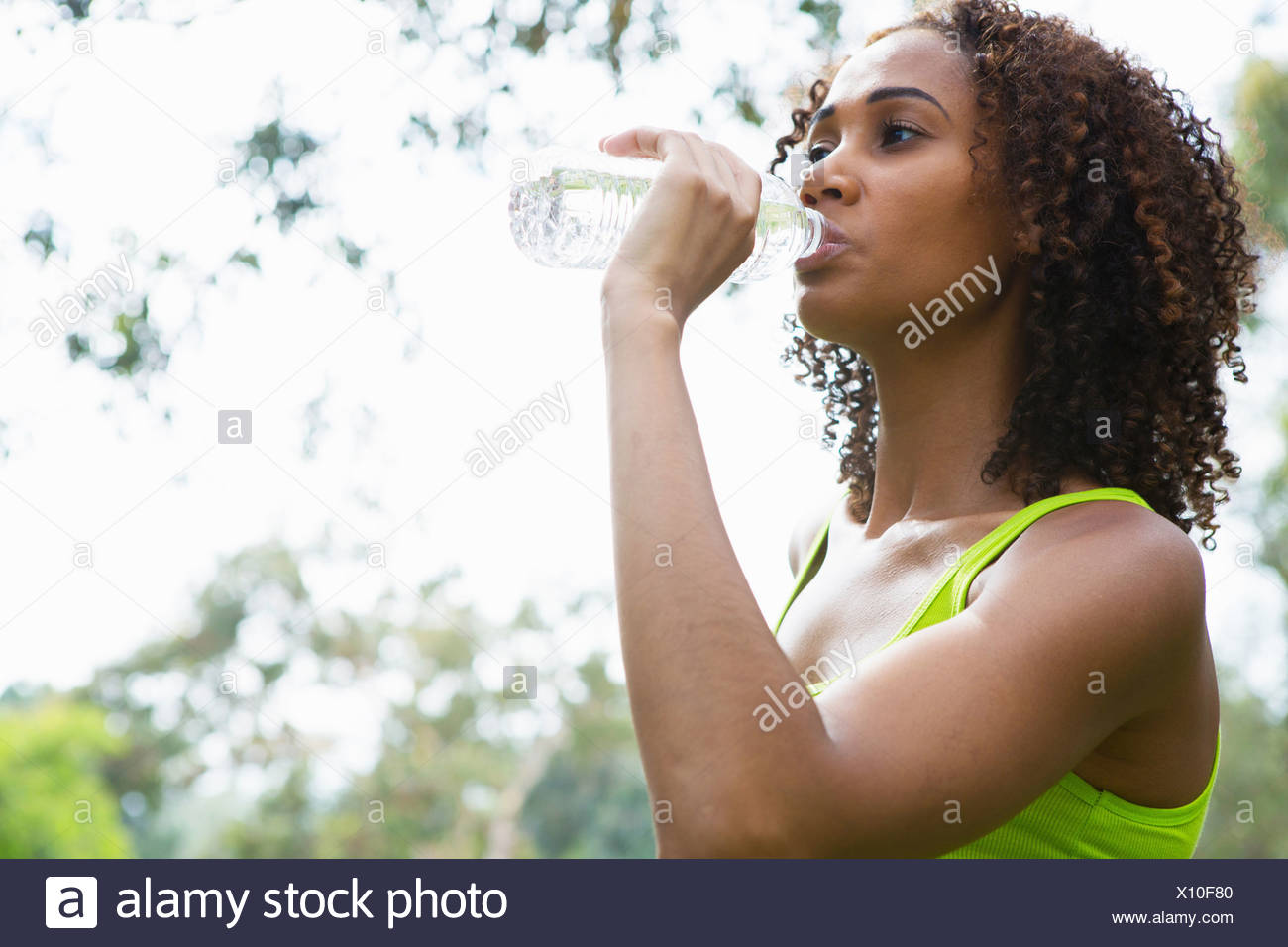 Mid adult woman drinking from water bottle Stock Photo