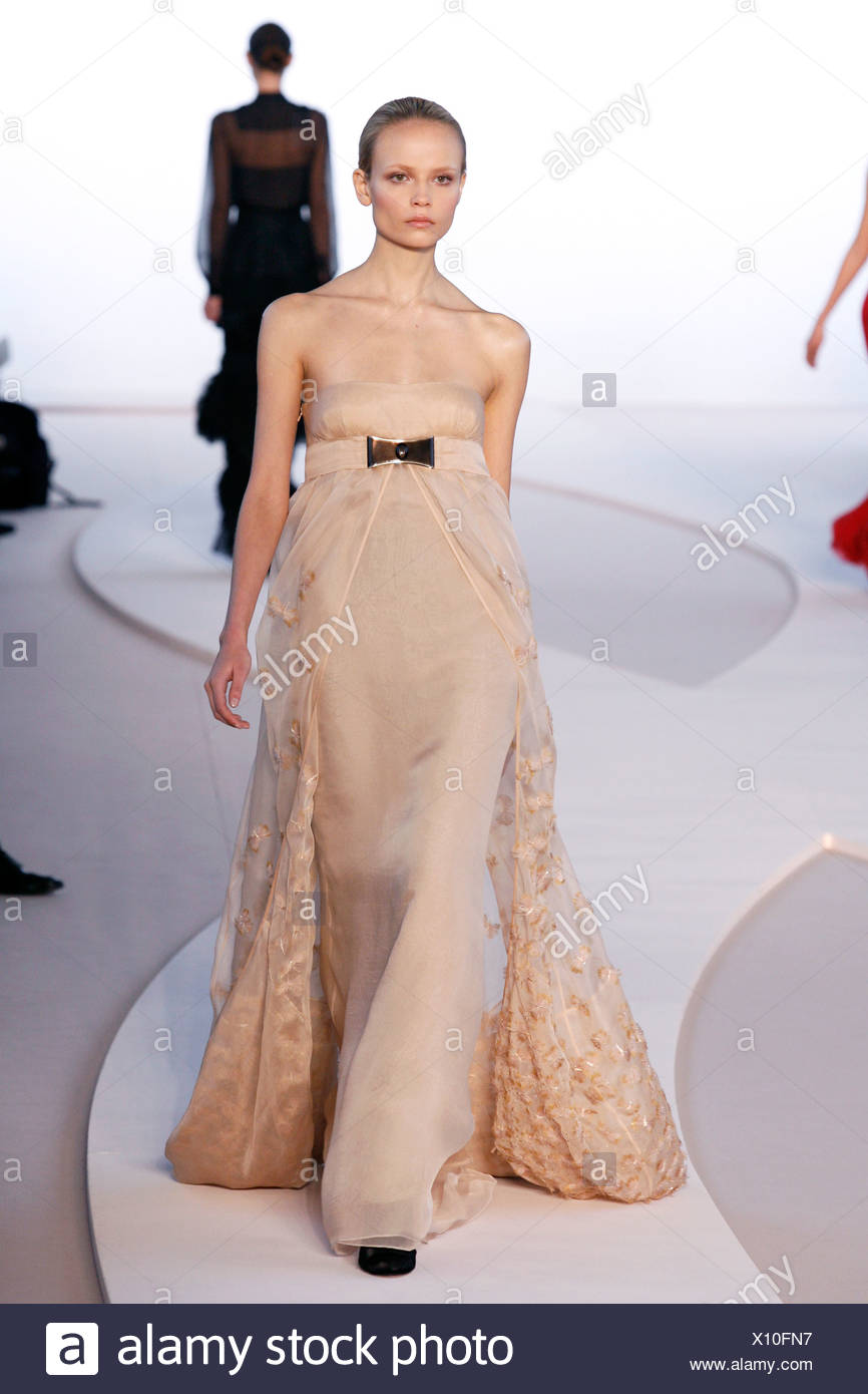 Valentino Paris Ready to Wear Autumn Winter Model wearing a pale peach  strapless flolength dress empire line and flower Stock Photo - Alamy