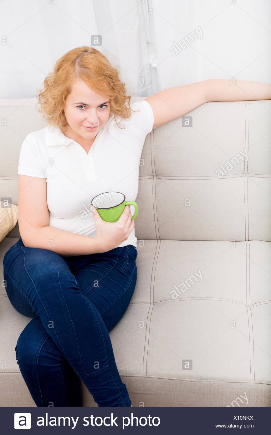 A Young Plus Size Woman Drinking A Cup Of Coffee Or Tea On The