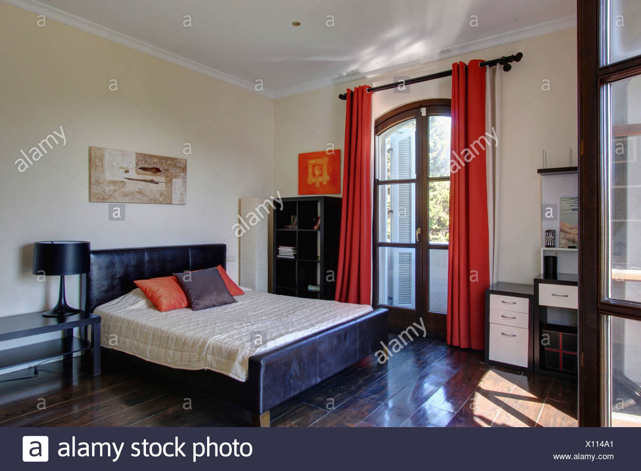 Red Curtains On French Windows In Spanish Bedroom With Black