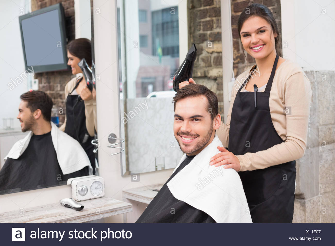 Hair Stylist And Client Smiling At Camera Stock Photo 276014263