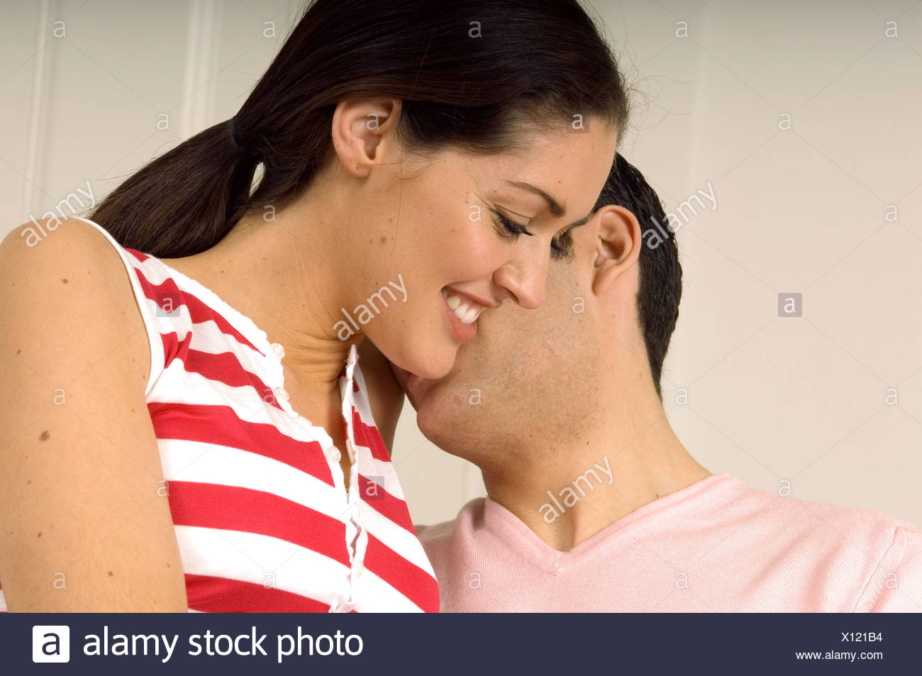 Male Short Brunette Hair Wearing A Pink Sweater And A Brunette