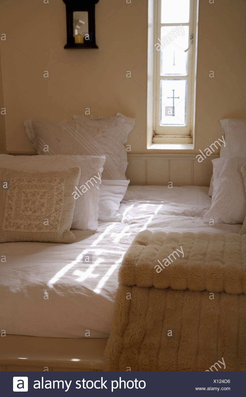 Cream And White Pillows With Beige Throw On Built In Bed