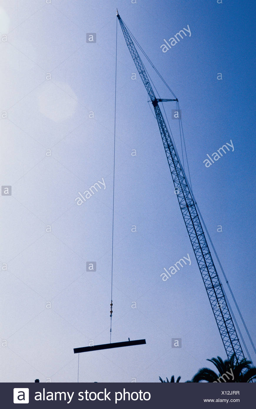 A Crane Lifting A Heavy Steel Beam Stock Photo Alamy
