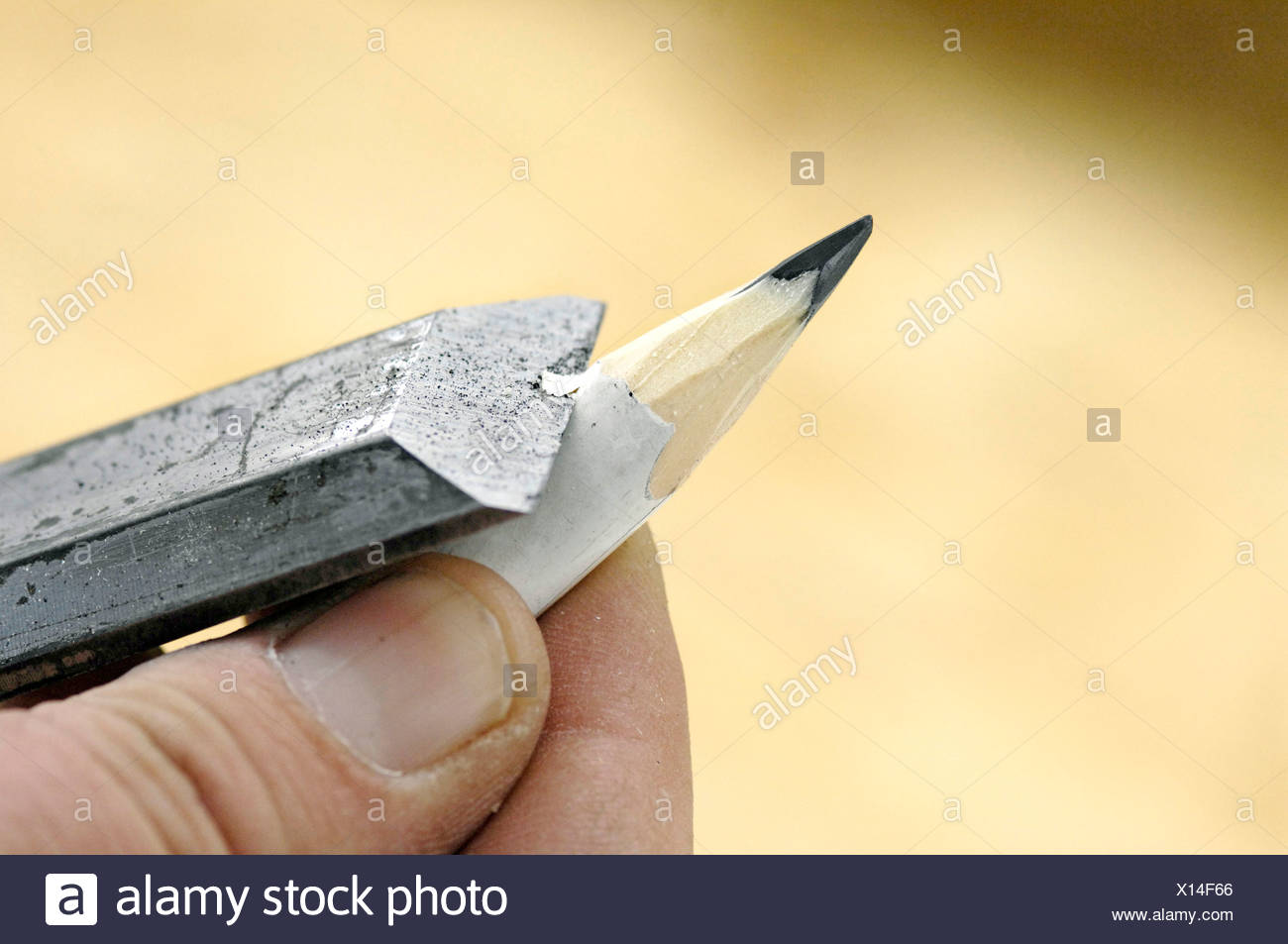 Sharpening a pen with a chisel, Carpentering Stock Photo