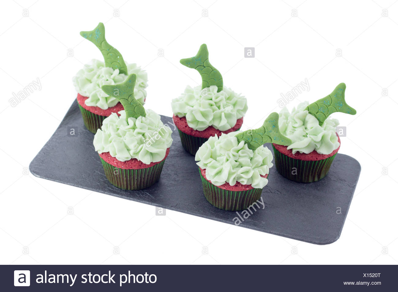 Five Tasty Cupcakes With Green Icing And Fish Tails Decoration On