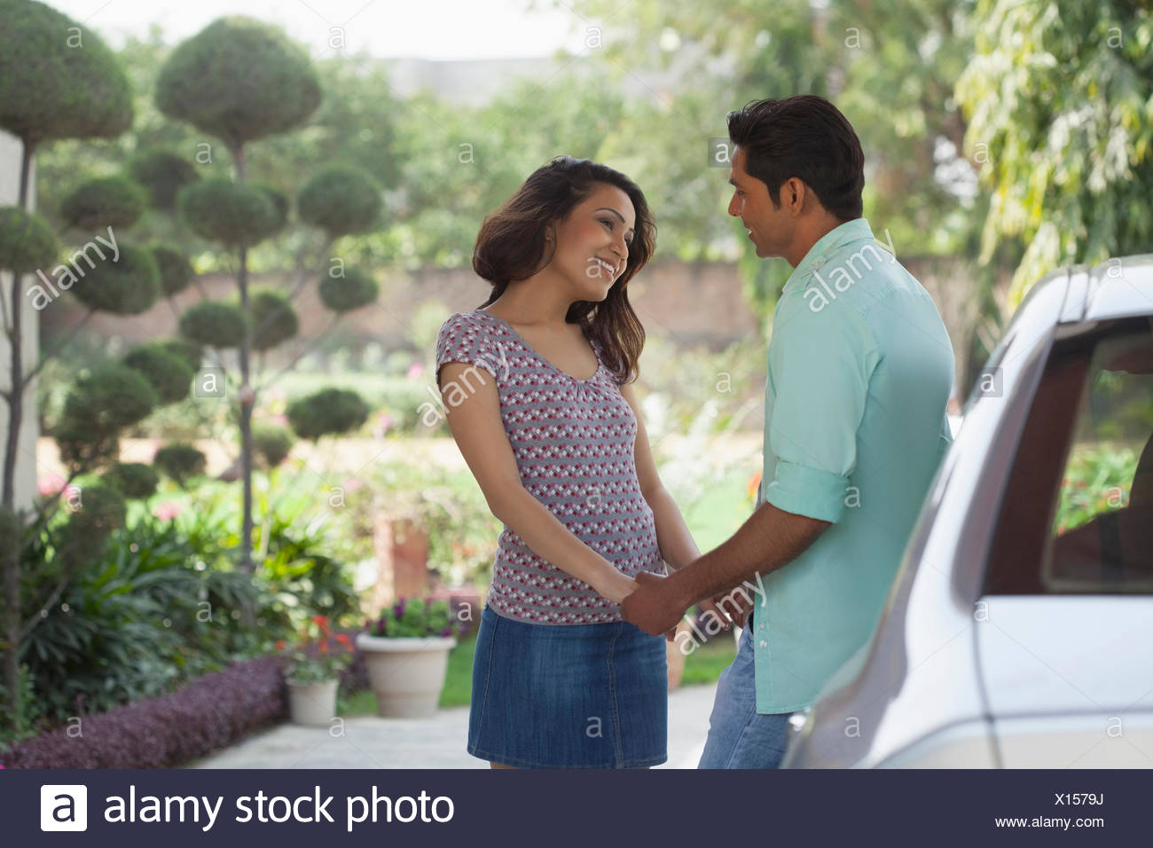 India Man And Woman Holding Hands Standing Next To Car Stock Photo Alamy
