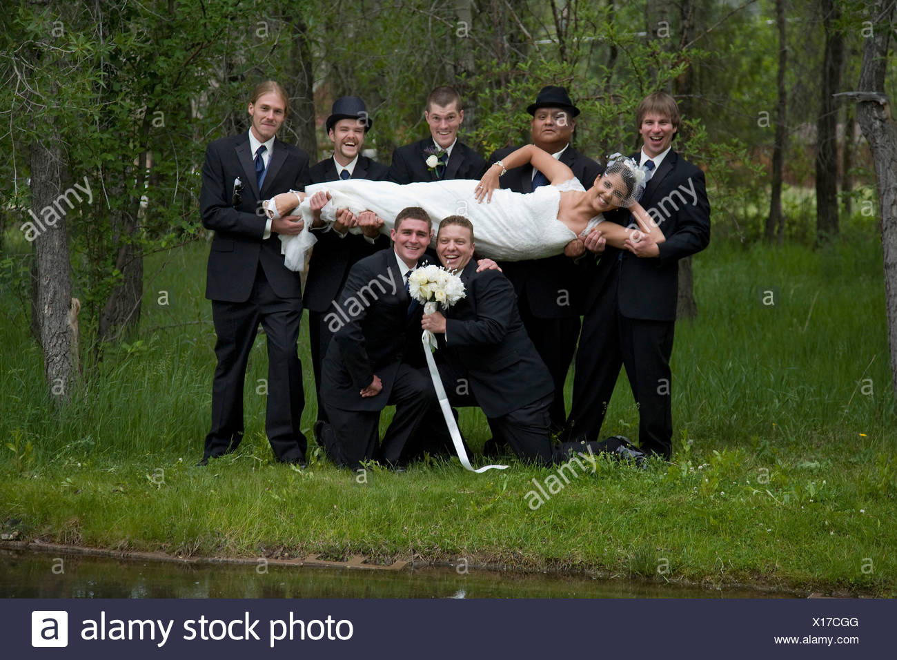 The Bride Poses With The Wedding Party After Her Outdoor Wedding