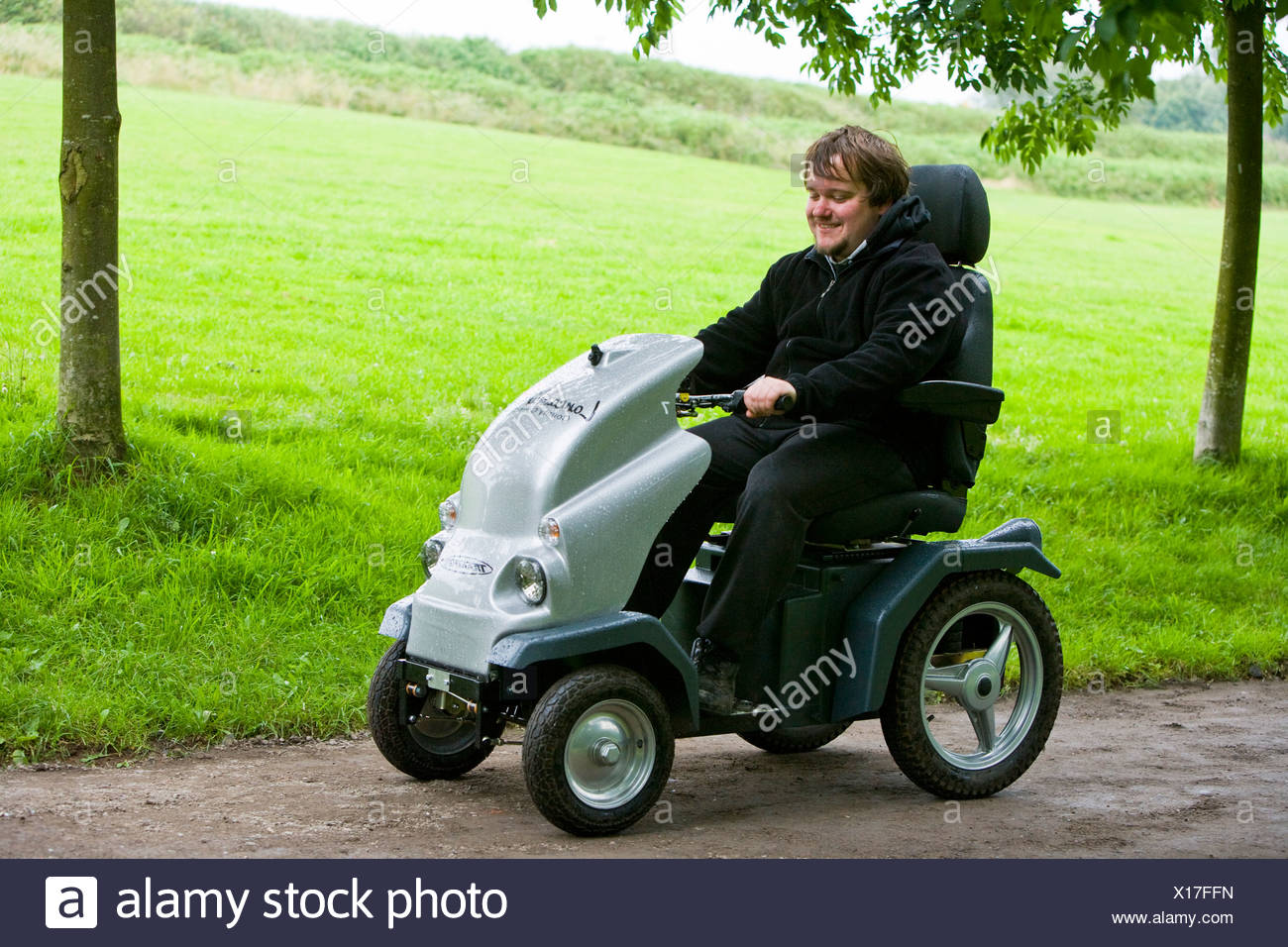 Disabled Man Using An All Terrain Electric Vehicle Stock Photo