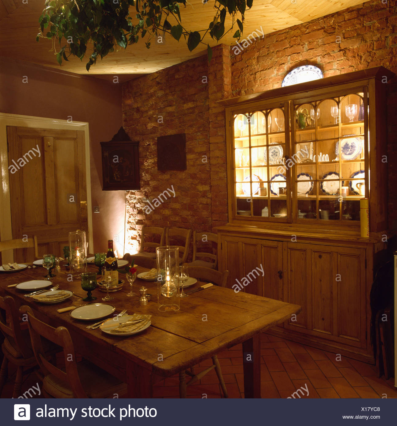 Lighted Shelves In Pine Dresser In Dining Room With Brick Walls