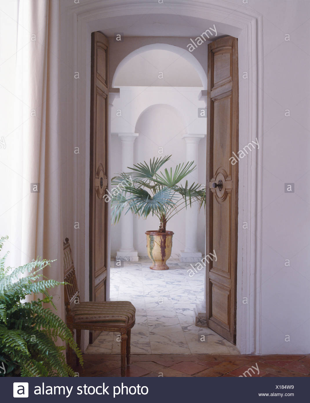 Open Double Wooden Doors In French Country Hall With
