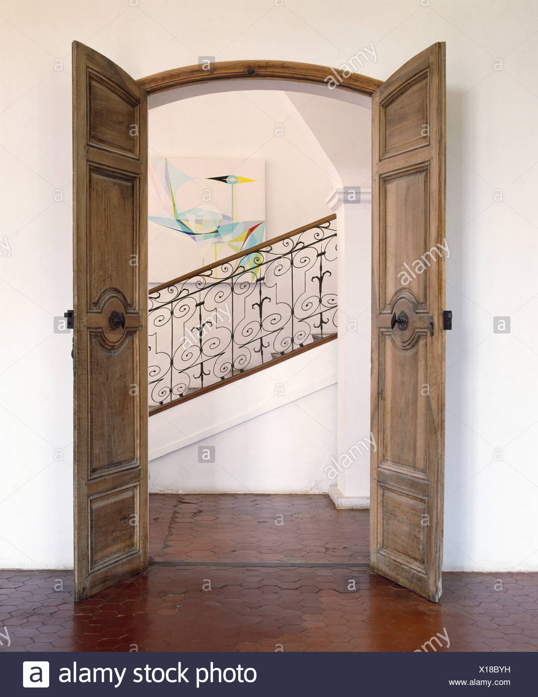 Open Double Wooden Doors In French Country Hall With View Of